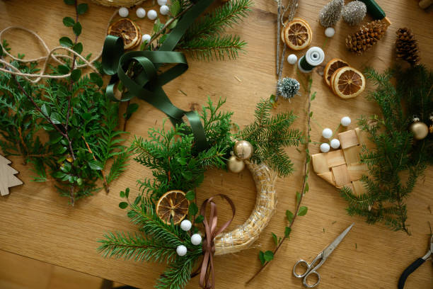 istock Christmas wreath in progress with natural decorations on a crafting table background 2176326777