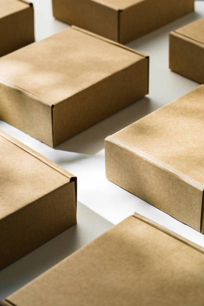 istock Brown cardboard boxes arranged on a light surface for packing goods in a warehouse setting 2176327978