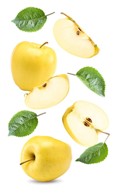 istock flying yellow apples with green leaf and slices isolated on a white background. clipping path 2176331920
