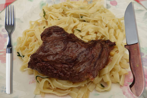 Browned sirloin steak served on tagliatelle with butter and basil
