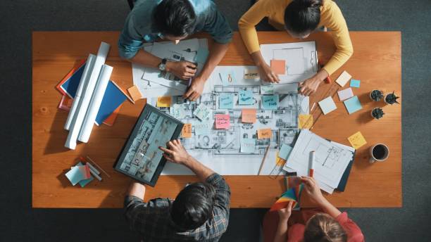 istock Top view of smart civil engineer discussing about house construction. Symposium. 2176337273