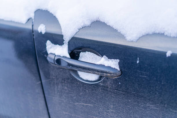 istock Snow covers the car door handle 2176337284