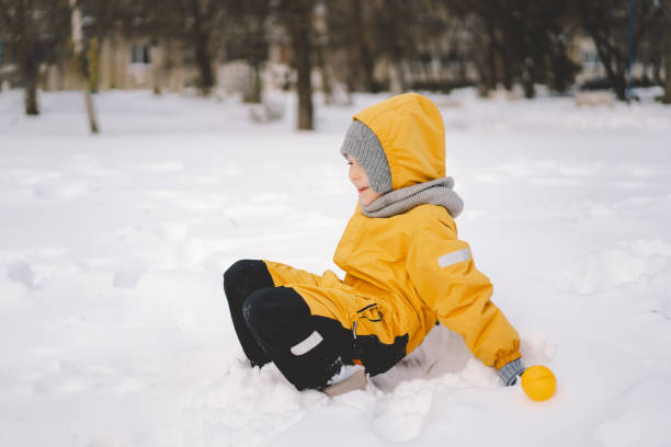 istock Young boy playing with a snowball maker in a cold winter day 2176337473