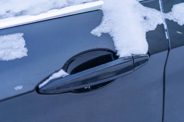 istock Snow covers the car door handle 2176337475