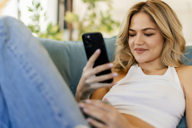 istock Young woman relaxing on sofa 2176340460