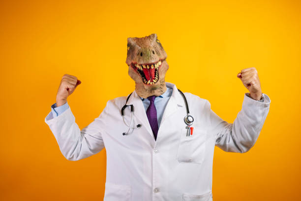 istock Doctor with dinosaur mask on a yellow background. 2176340833