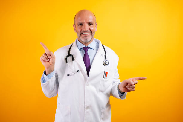 istock A doctor in a white coat with a stethoscope is smiling and pointing to both sides. 2176340927