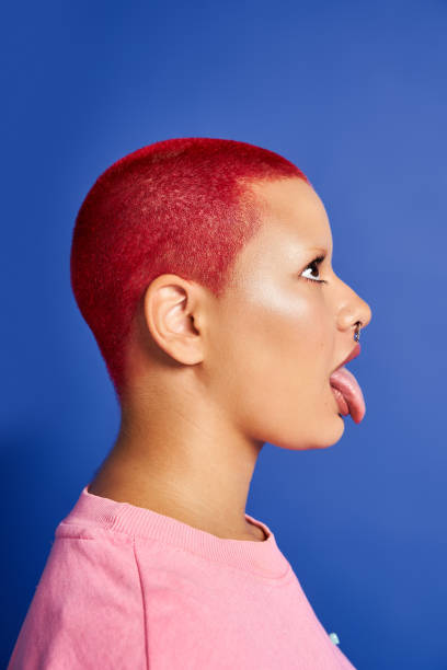 istock A young woman with bold pink hair expresses her unique style in a vibrant studio setting 2176341466