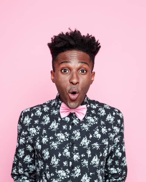 istock Surprised afro american guy against pink background 2176341767