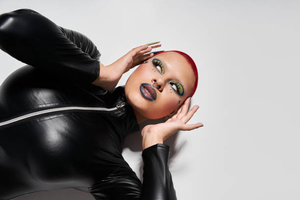istock Young woman with pink short hair expresses bold style in a modern studio setting 2176342843