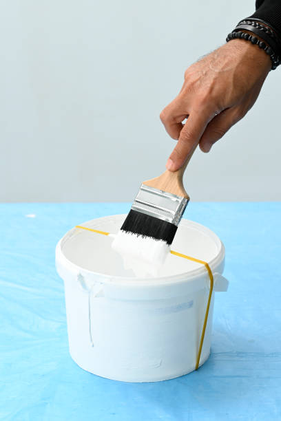 istock Using a rubber band across its center causes the paint will drip across the rubber band and back into the can to minimize the mess. 2176343660