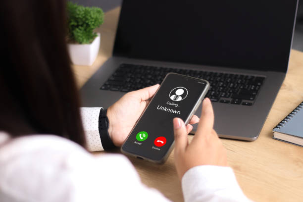 istock Unknown number displayed showing on smart mobile phone. Human use smartphone with incoming call from unknown number, spam, hacker, call center, crime, 2176345798