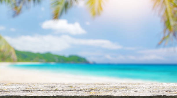istock An empty wooden table in the foreground, set against a sunny sea horizon 2176346204