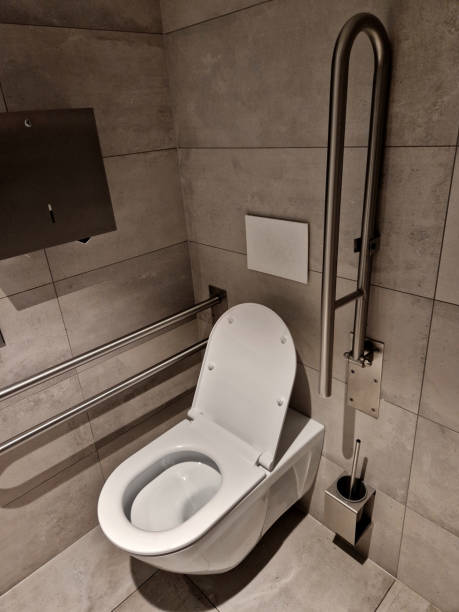 istock toilets for wheelchair users and disabled people have a tilting mirror that points to the ground because the height of the person sitting is lower. lever taps for easier water temperature adjustment 2176351132