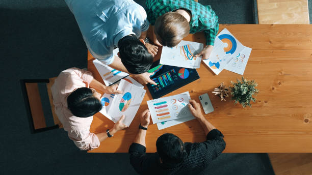 istock Top down view of business people analyze data together at meeting. Convocation. 2176351212