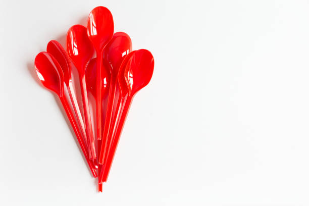 istock Top view of red plastic spoons over a white table. 2176351717