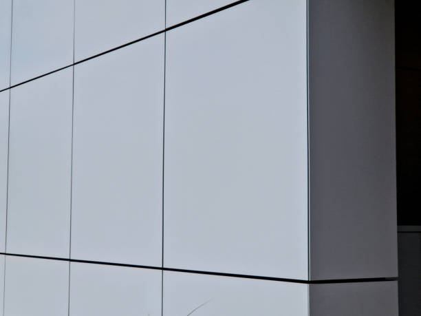 istock cladding of a building with a expanded metal lattice structure. galvanized gray nets protect the industrial building. Blue sky in contrast to a silver background, wall, corner, slanted, sheet metal 2176352363