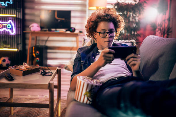 istock Teenage boy playing mobile game at home 2176352369