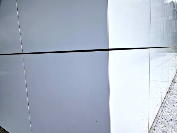 istock cladding of a building with a expanded metal lattice structure. galvanized gray nets protect the industrial building. Blue sky in contrast to a silver background, wall, corner, slanted, sheet metal 2176352372