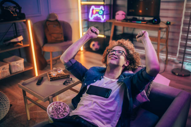 istock Teenage boy playing mobile game at home 2176352557