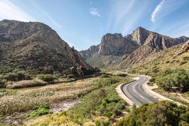 Tar road winding through majestic mountain range