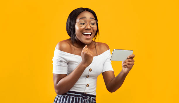 istock Excited Black Girl Holding Smartphone Gesturing Yes, Studio Shot 2176355580
