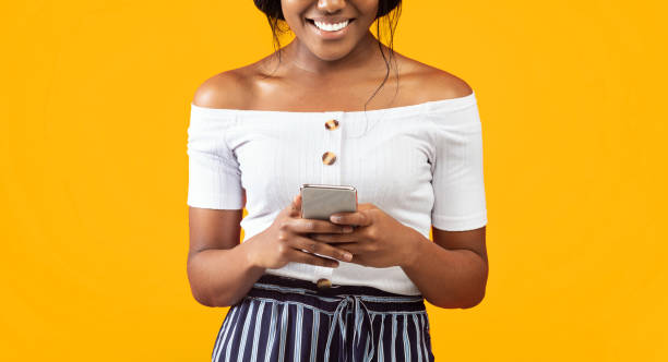 istock Afro Woman Using Smartphone Standing Over Orange Background, Cropped, Panorama 2176355651