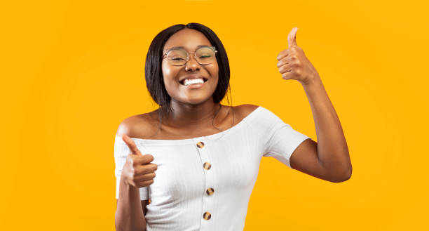 istock African American Girl Gesturing Thumbs Up Standing, Panorama, Studio Shot 2176355656