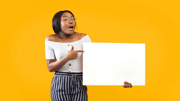 istock African American Lady Pointing Finger Holding White Board, Studio, Mockup 2176355658