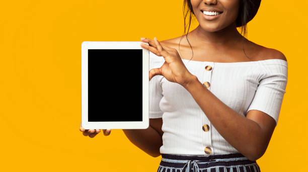 istock Unrecognizable Girl Showing Tablet Screen Standing On Orange Background, Mockup 2176355661