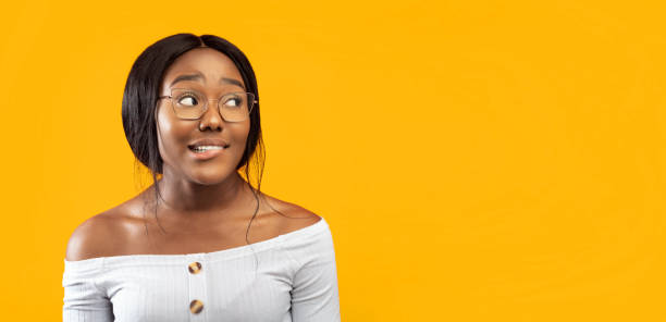 istock Afro Girl Biting Lips Standing Over Orange Studio Background, Panorama 2176355686
