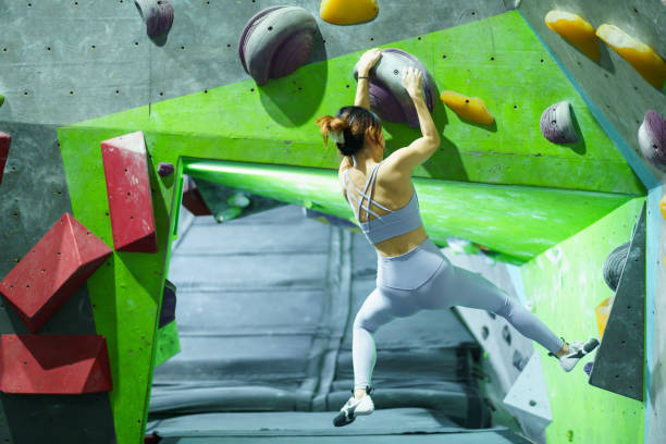 istock Asian sportswoman practices an indoor rock climbing wall. 2176358260