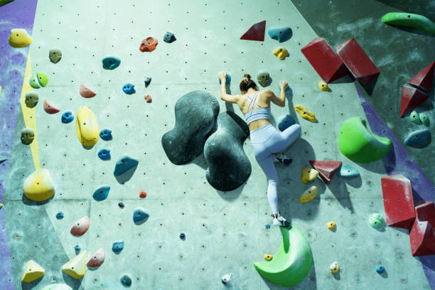 istock Asian sportswoman practices an indoor rock climbing wall. 2176358312