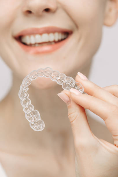 istock A woman uses an orthodontic silicone trainer for teeth correction. This mobile device highlights modern dental care methods and whitening systems, promoting a healthy and radiant smile. 2176361541