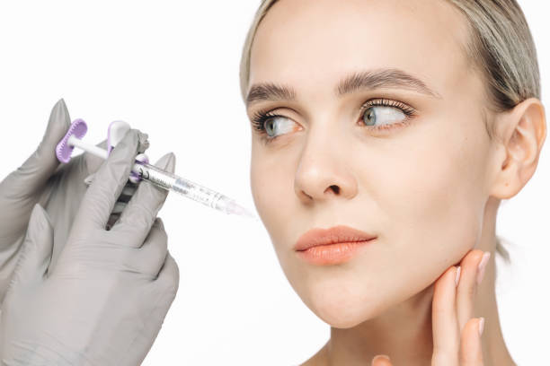 istock A woman confidently poses against a white background beside a syringe. This image captures the essence of cosmetic services, highlighting the importance of self-care and skin health. 2176361728