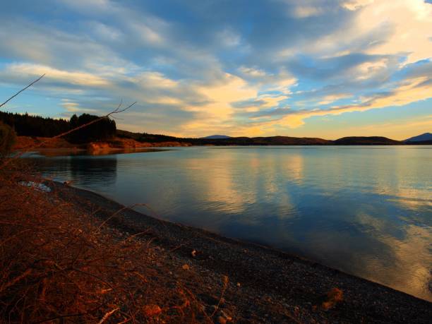 istock Golden Sunset Reflections on a Tranquil Lake 2176362845