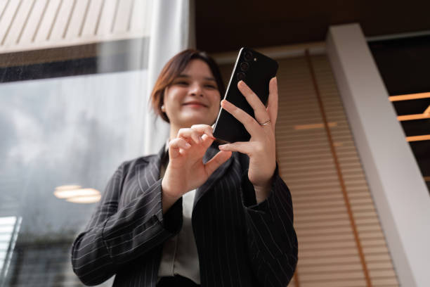 istock Confident Businesswoman Using Smartphone for Customer Communication in Modern Office Setting 2176362887