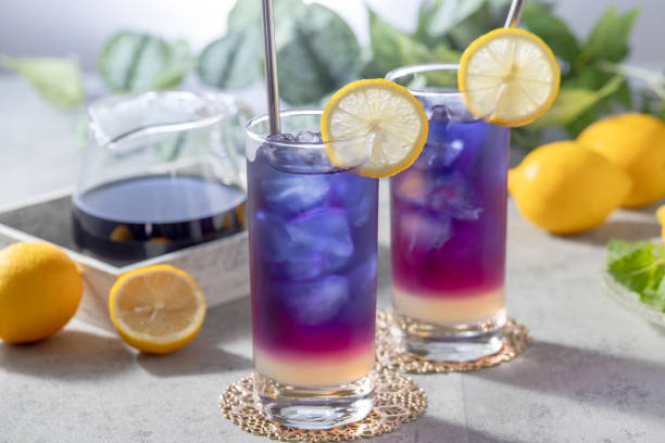 istock Lemonade with blue and violet butterfly pea flower tea on light gray background with copy space 2176363172