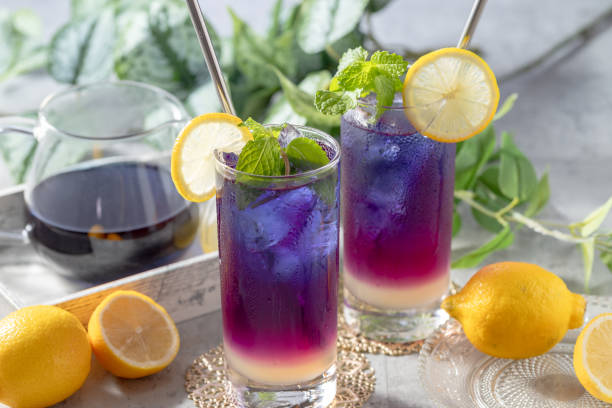 istock Lemonade with blue and violet butterfly pea flower tea on light gray background with copy space 2176363209