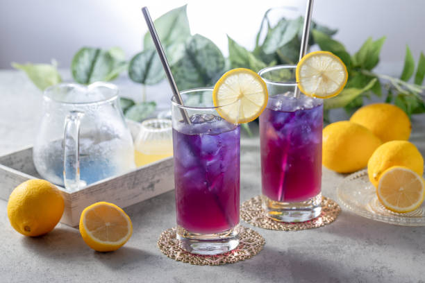 istock Lemonade with blue and violet butterfly pea flower tea on light gray background with copy space 2176363227