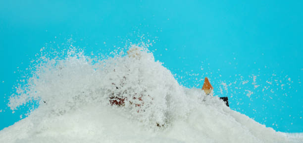 Snow fall cover house over blue sky background isolated. Winter snow storm falling on house like avalanche from climate change extreme weather disaster