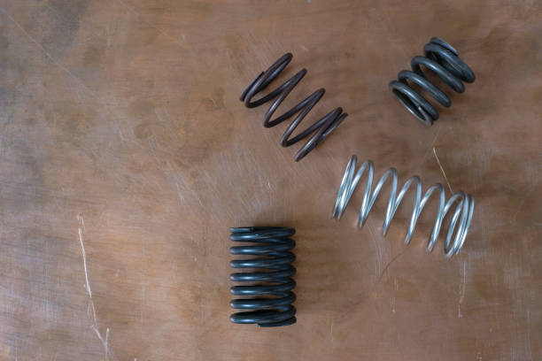 Metal Coil springs on a white background, spare parts, Vehicle spare parts for repair and service.