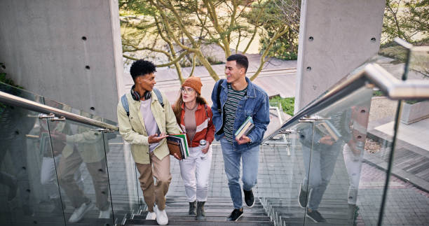 istock Development, education and walking with friends on stairs at college or university campus for learning. Conversation, growth or study with man and woman students outdoor at school together for future 2176368169