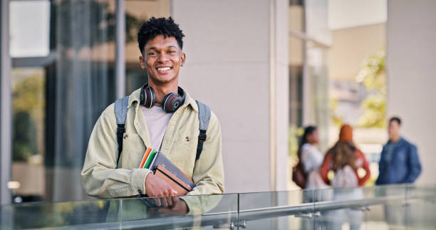 istock Man, university student and happy in outdoor with pride for education, progress and study. Male person, college learner and smile on portrait with confidence for exams and assessment 2176368195