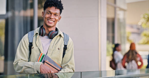 istock Man, university student and smile in outdoor with pride for education, progress and study. Male person, college learner and happy on portrait with confidence for exams and assessment 2176368209