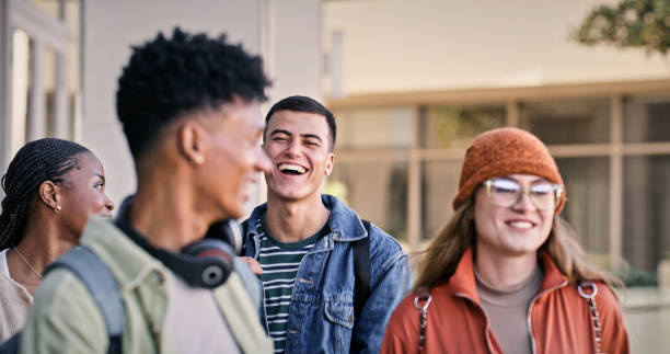 istock Group, students and happy with people, smile and backpacks for walking on campus or university. Friends, outdoor and talking for education, development and scholarship for learning, college or school 2176368241