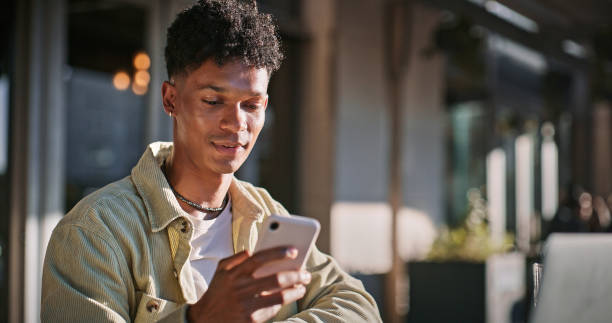 Man, student and typing with phone outdoor for communication, scholarship feedback and opportunity. Male person and scroll on mobile app with education schedule, reading offer and university results