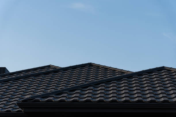 istock Rooftops with textured tiles are visible under a bright blue sky, highlighting the tranquil atmosphere of the suburban neighborhood on a sunny afternoon 2176369747