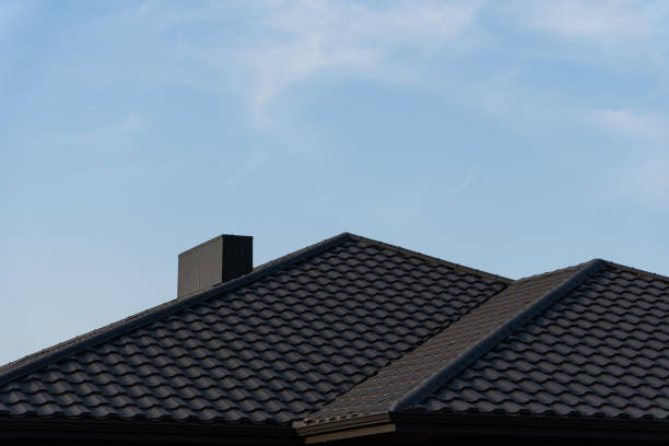 istock The structure features two gabled roofs with textured tiles, standing prominently under a bright blue sky, highlighting the craftsmanship of the residential architecture 2176369761