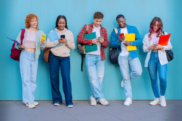 istock Five students having fun with mobile phones creating content on social media. 2176370786